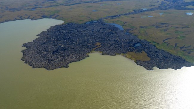 aerial photo a coast line with a lava flow