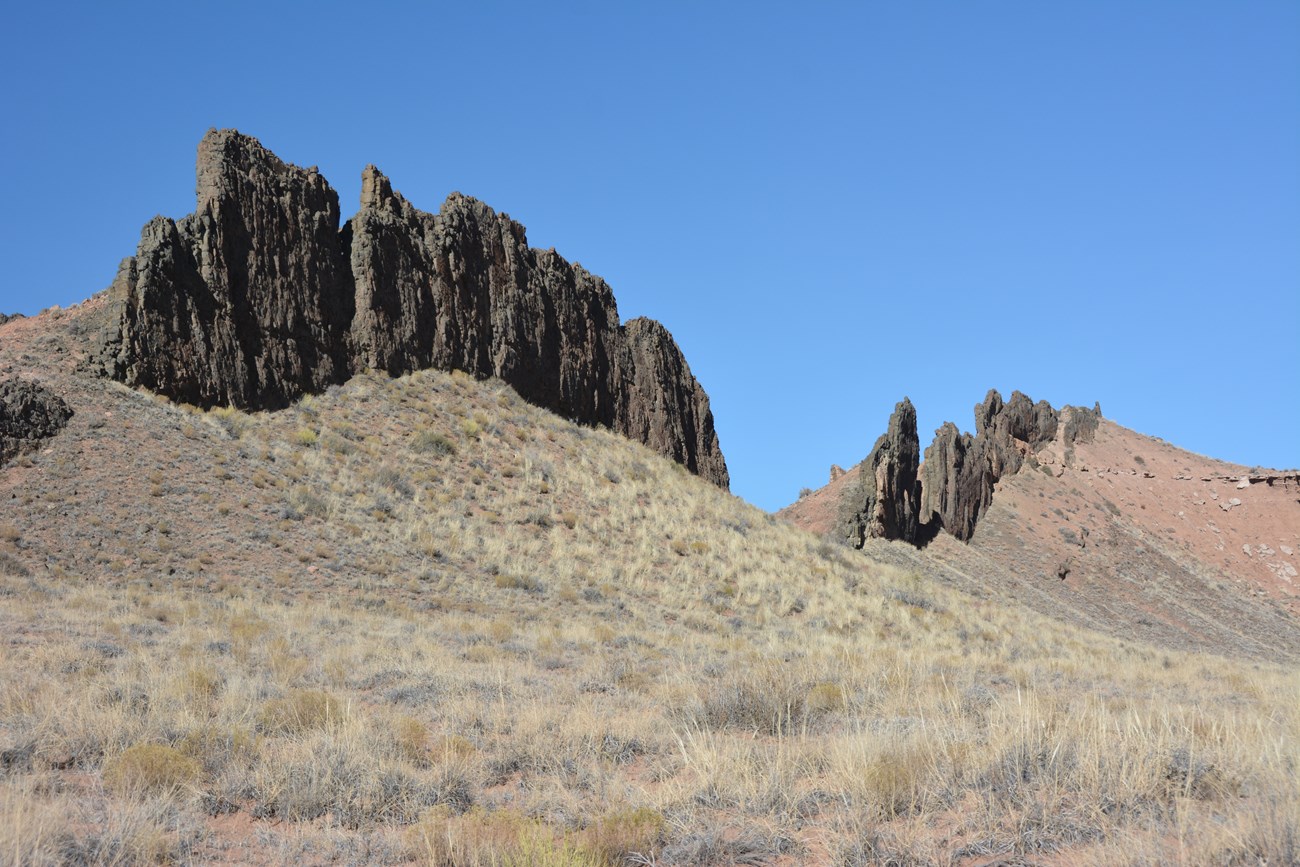 photo of rock spires at the top of a hill