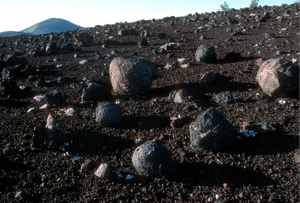 rounded lava rocks on cinder covered ground