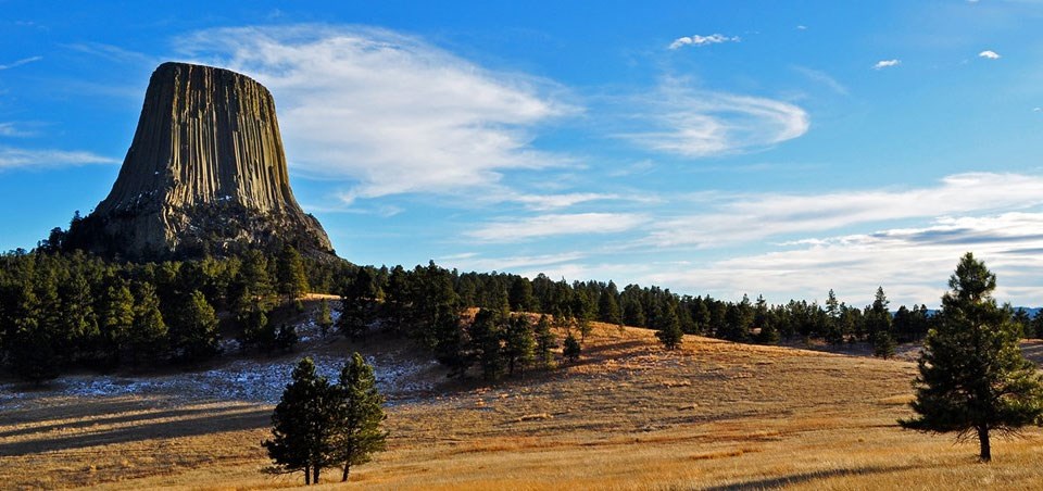photo of devils tower monolith standing tall above the surrounding landscape