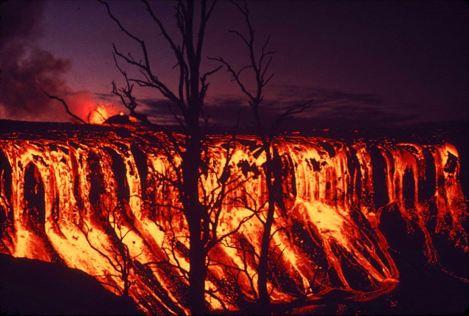 Glowing lava cascading at night