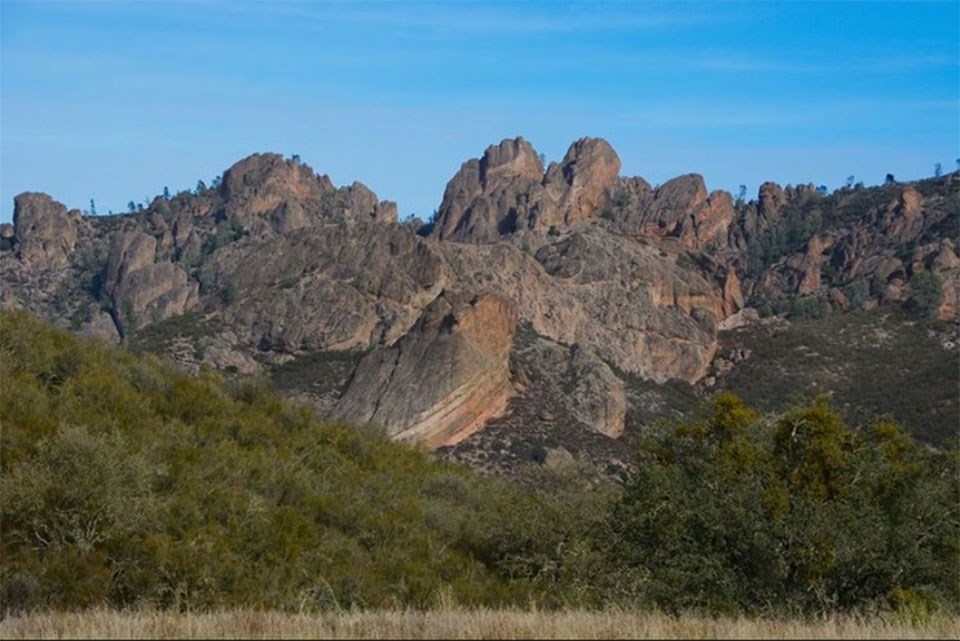 pinn-nps photo of a mountain side with rock spires and eroded bedrock