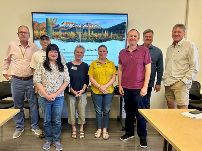 Excellence in Wilderness Stewardship External Partner Award recipients Friends of Saguaro National Park. Board members of the organization Friends of Saguaro National Park stand together in a room with a presentation behind them.