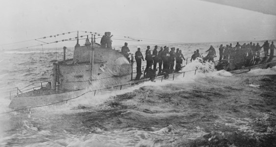 German submarine surrenders to U.S. Navy A German submarine crew stands on the deck as waves crash over the sides.