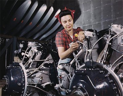 Woman working on an airplane motor at North American Aviation, Inc., plant in Calif.