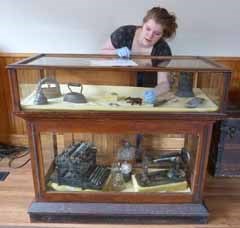 student intern organizes an exhibit case