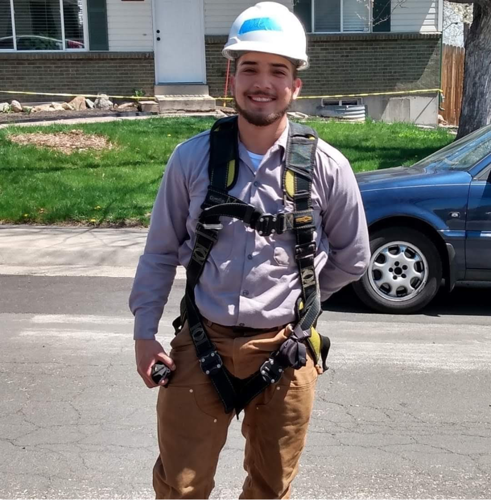 Joseph Cordova posing outdoors with a hard hat at a work site (Groundwork Denver) Photo of Joseph Cordova (Groundwork Denver)