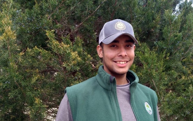 Kalen Anderson smiling while wearing an Appalachian Conservation Corps jacket