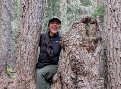 A woman perched on a tree