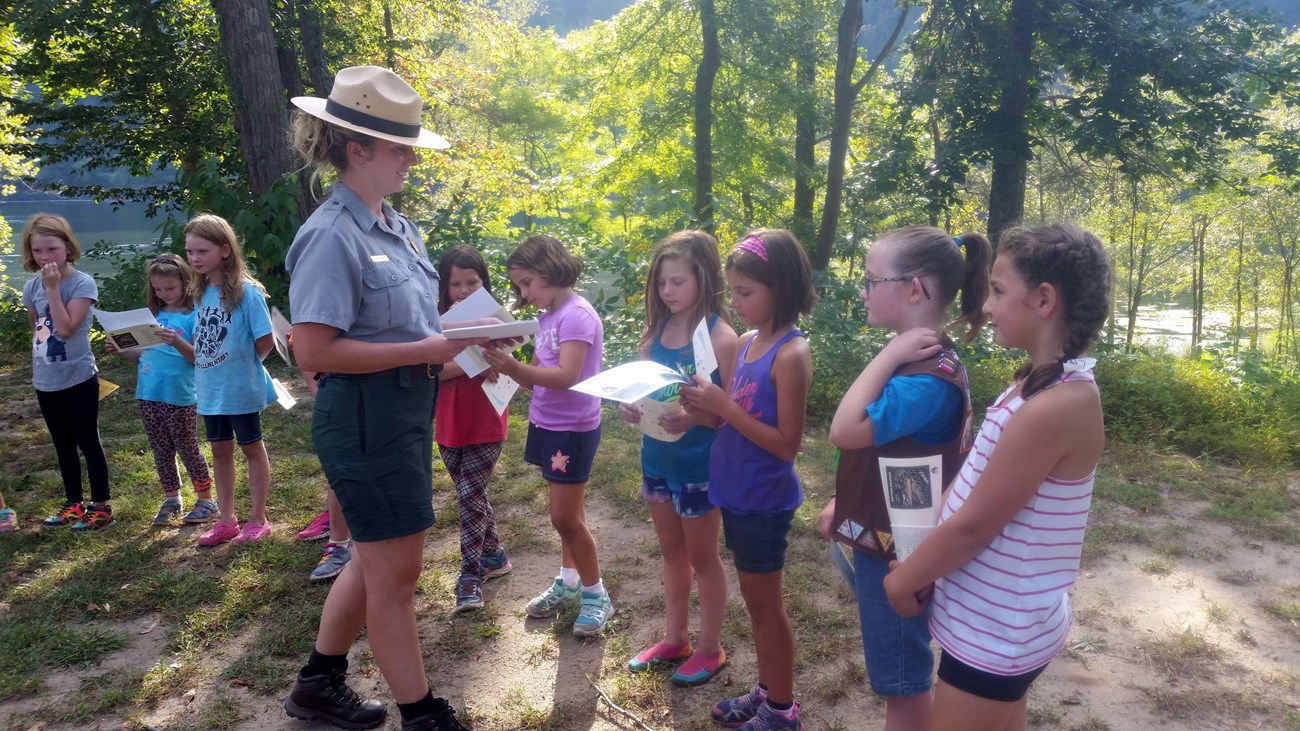 Girl Scout Ranger leaders hands out awards.