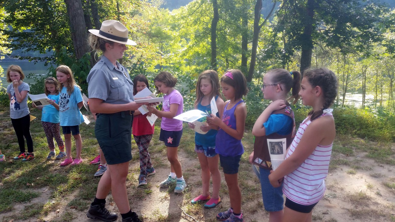 lt= Girl Scout Ranger leaders hands out awards.