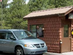 A park ranger at entrance station gives directions