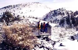 Hikers in snow-covered lava landscape