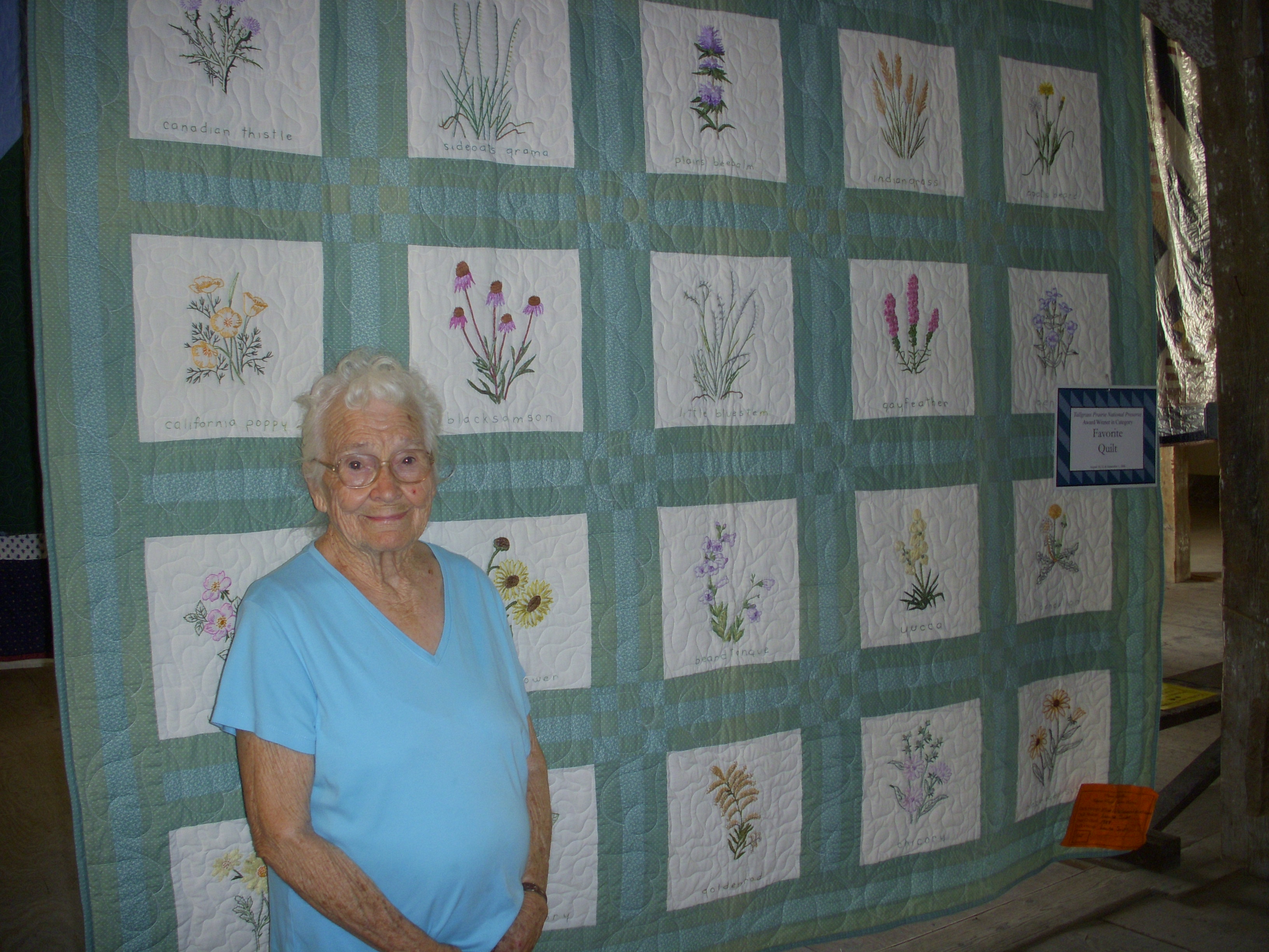 Beautiful embroidery wildflower quilt on display in the barn