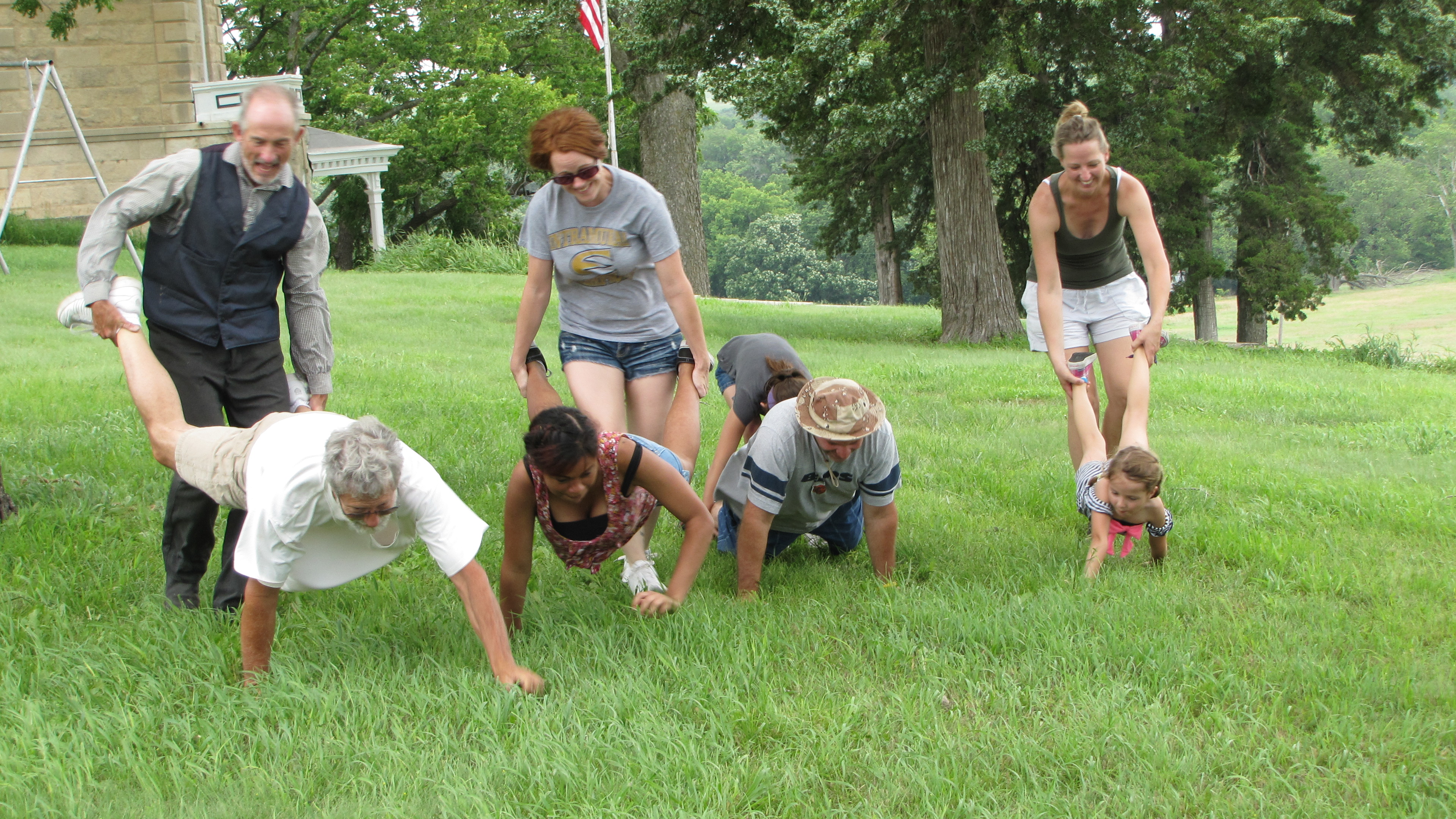 visitors having fun doing the wheel barrow race