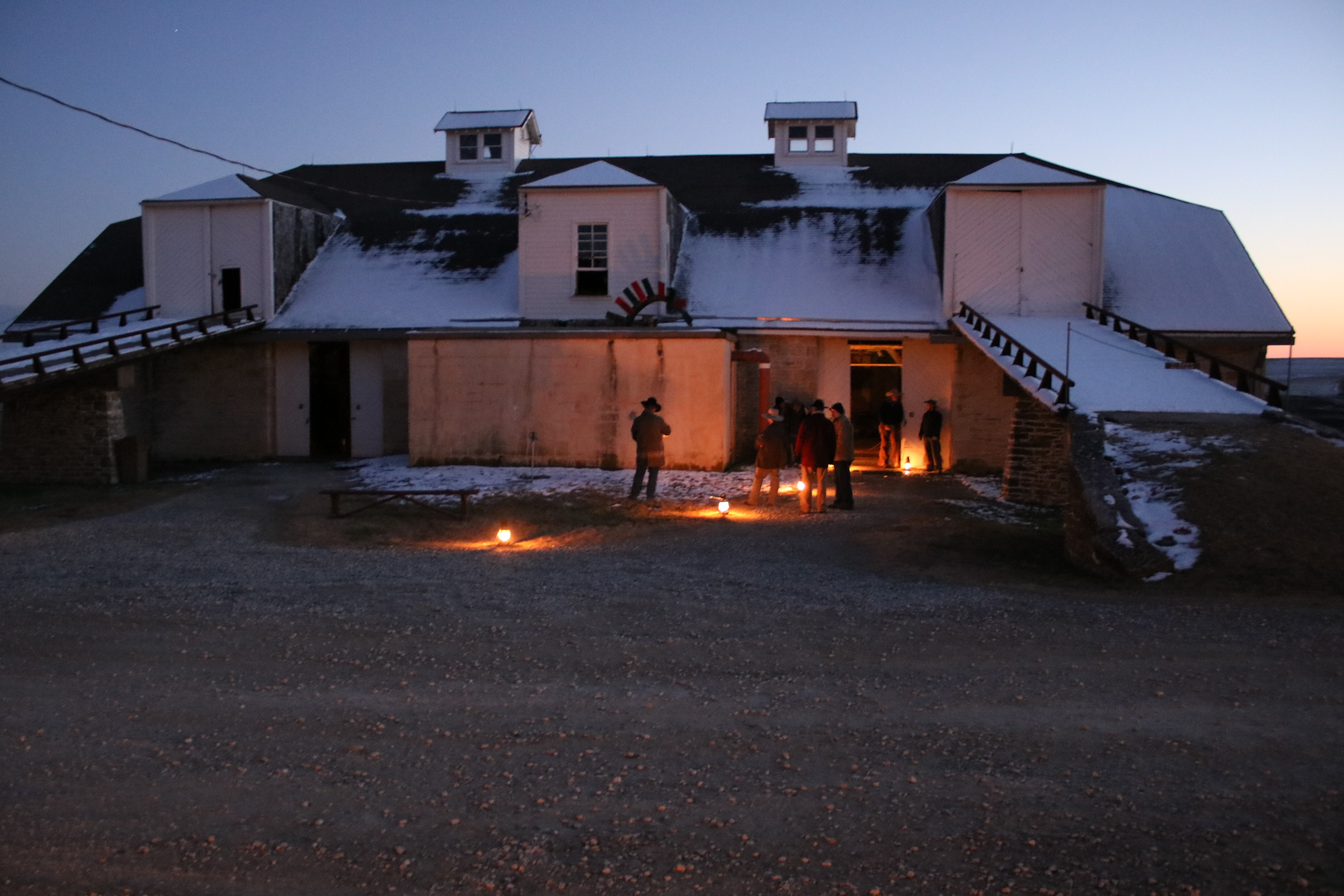 Historic limestone barn lit by kerosene lanterns