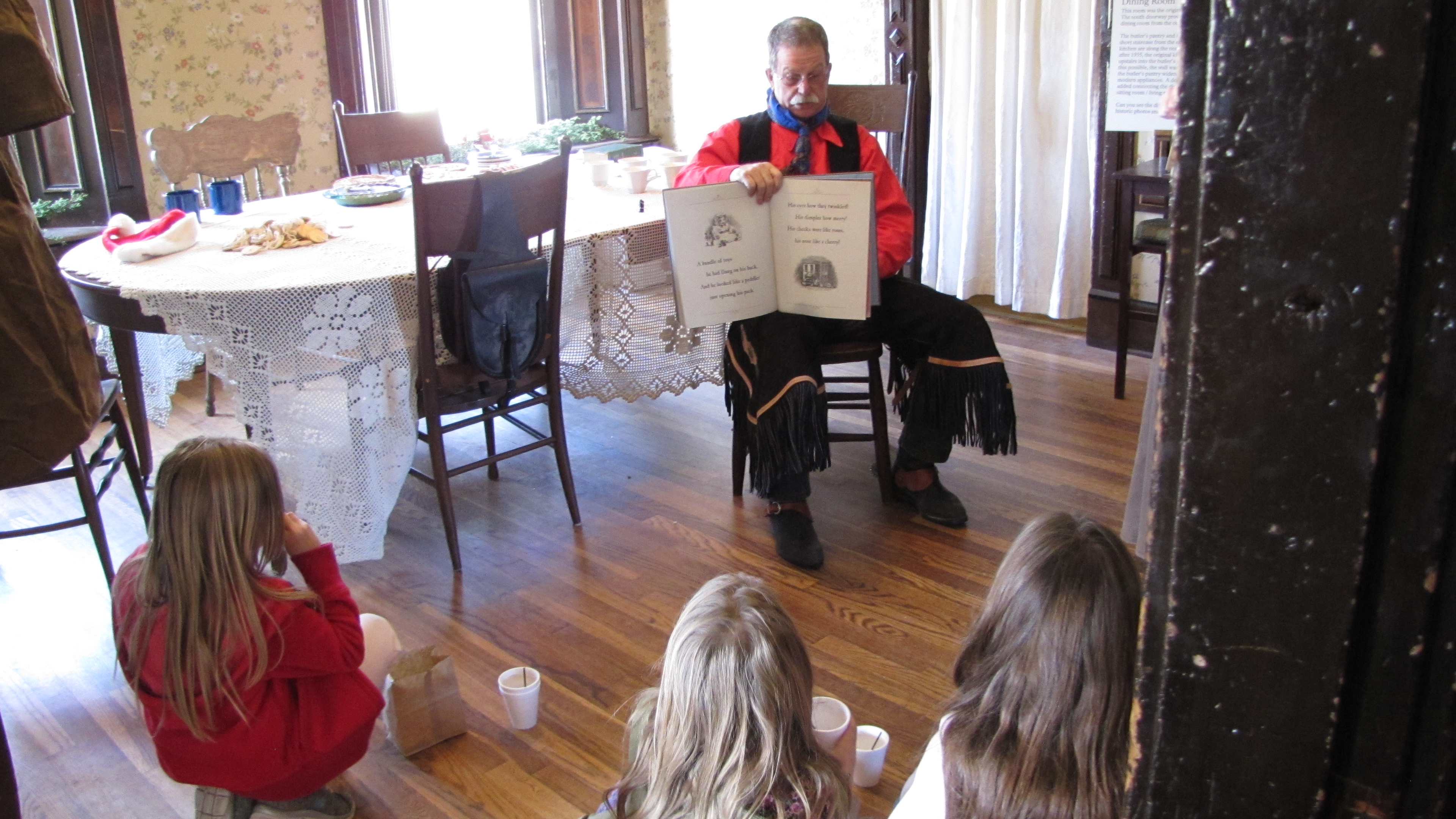 Children being read to by cowboy