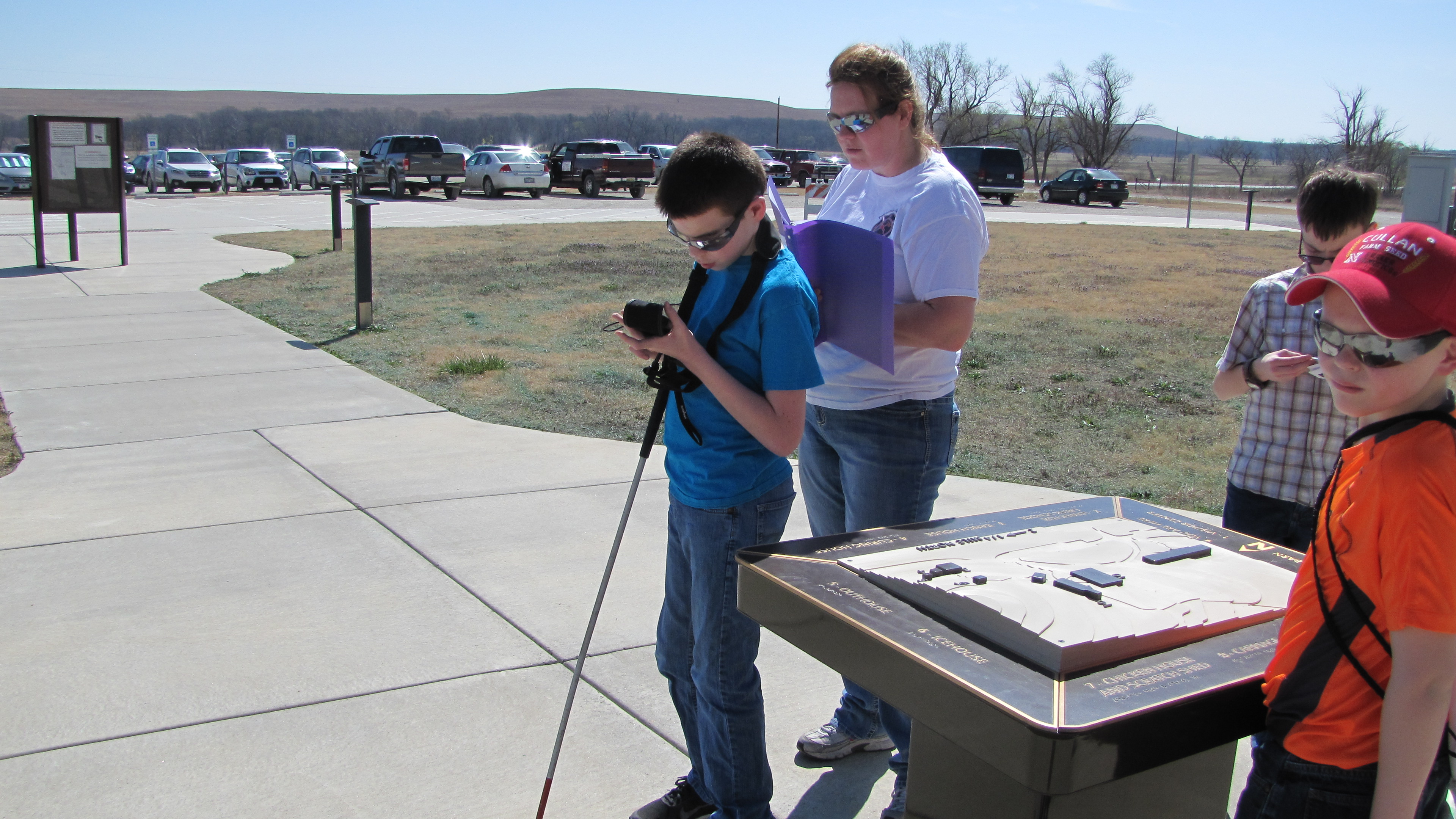 Visually impaired student using accessibility device at the preserve.