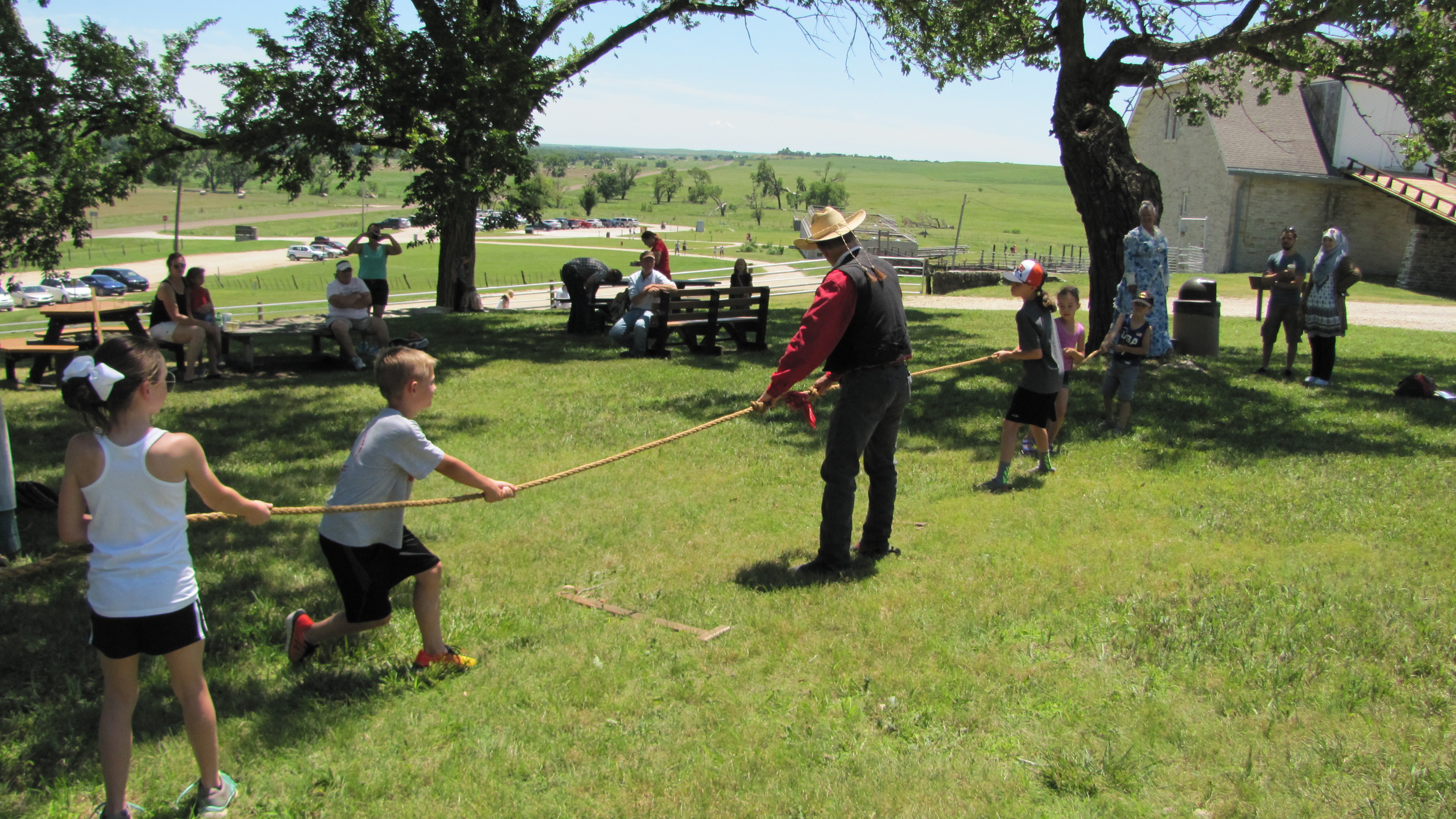 Kids having fun with historic games during Independence Day with a game of Tug of War at the preserve.