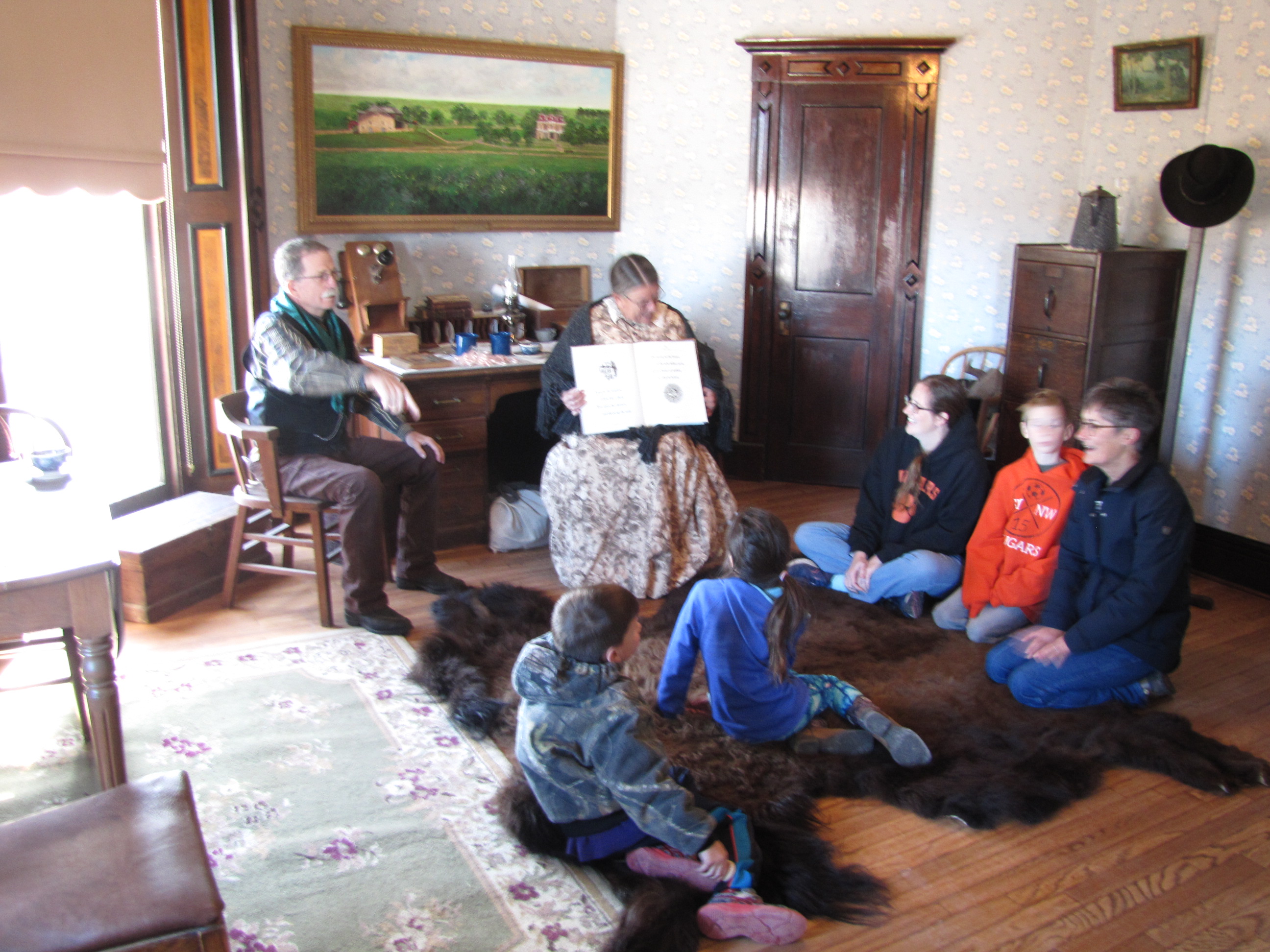 Children listening to Twas the Night Before Christmas being read aloud.