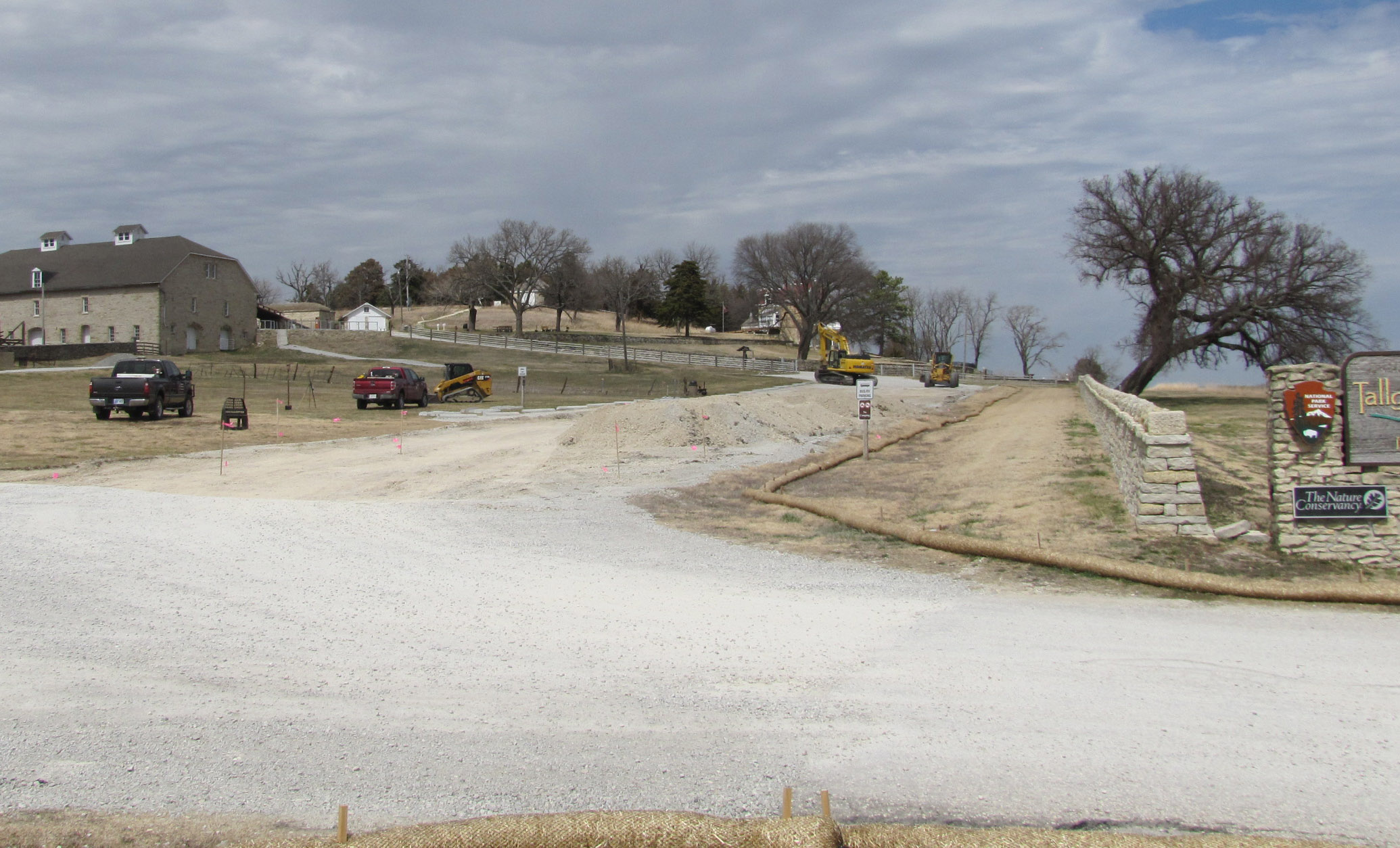 Pile of gravel and heavy equipment parked on the parking lot that will be paved. Pile of gravel and heavy equipment parked on the parking lot that will be paved.