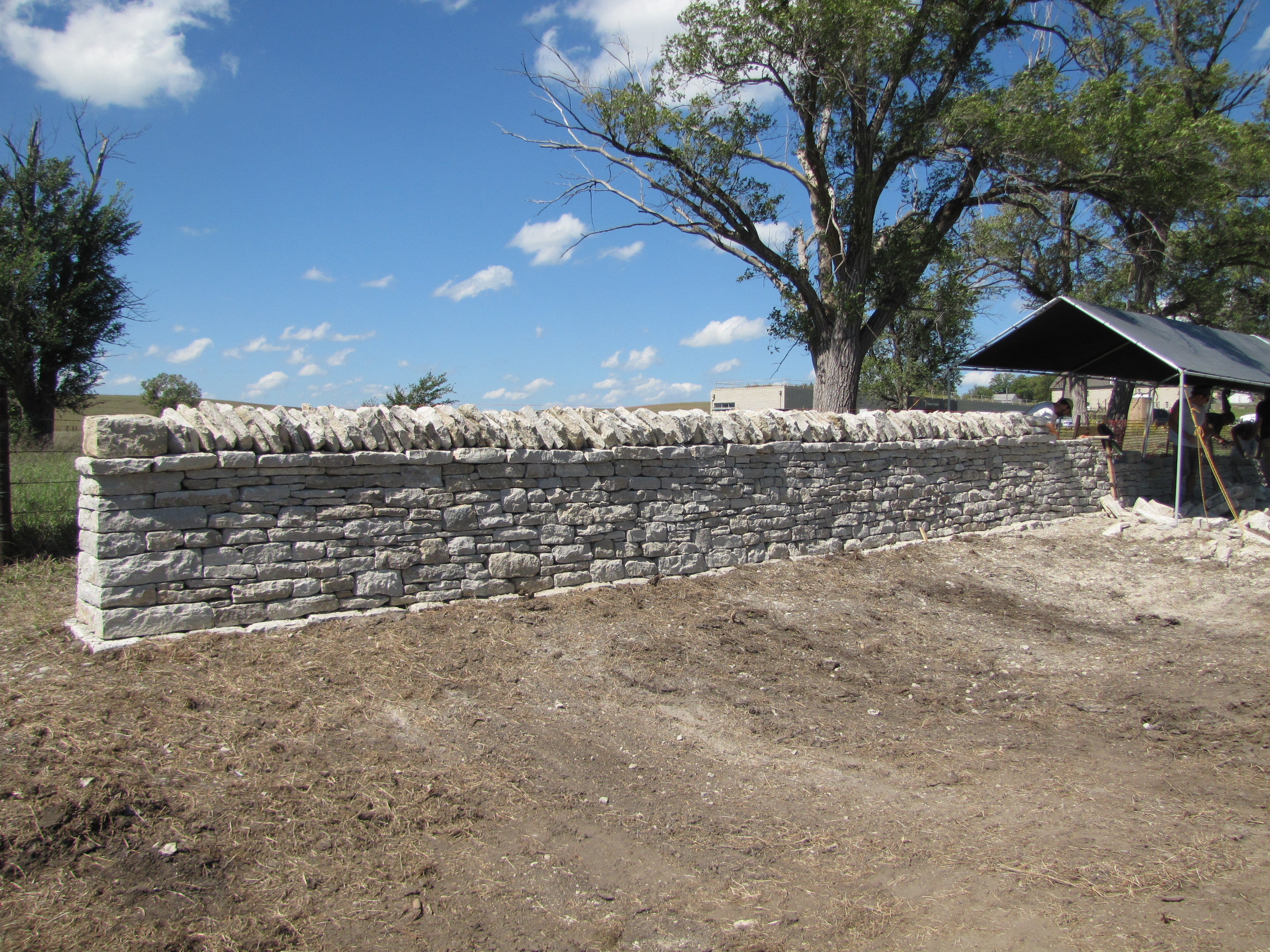 stone fence being rehabilitated at the preserve