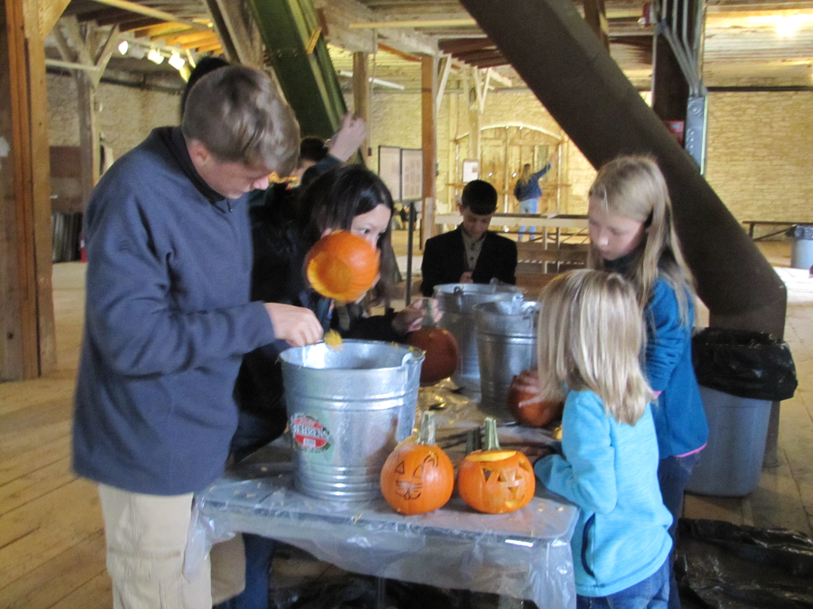 Kids carving pumpkins and having fun
