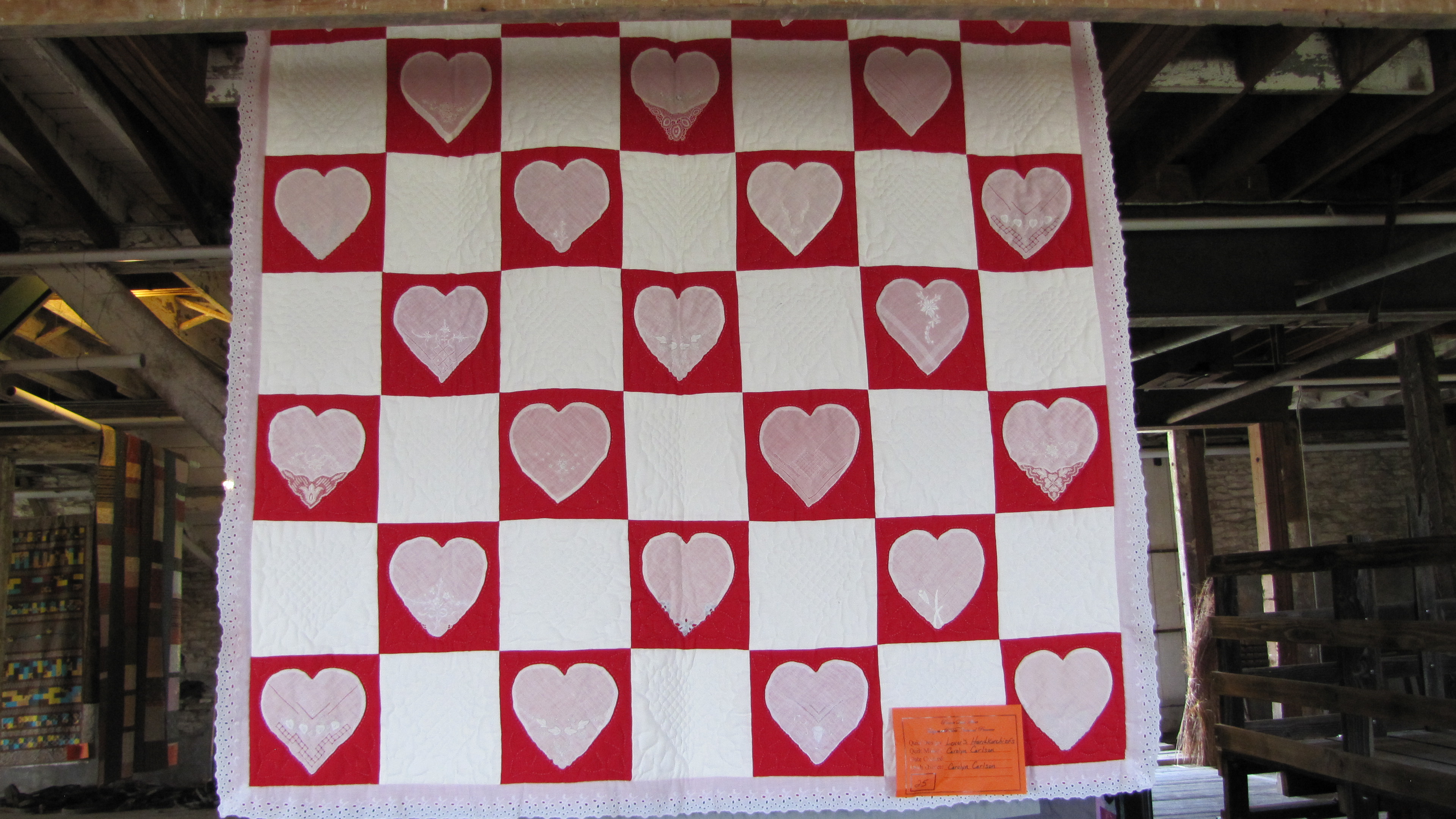 red and white quilt on display in the barn