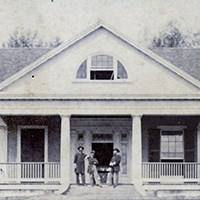 The Burn house with three Federal troops standing on porch