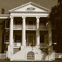 Choctaw three-story house featuring circular steps leading to porch