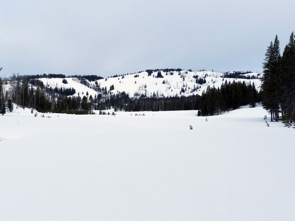 The frozen Cascade Lake covered in snow as taken from along the ski trail. The frozen Cascade Lake covered in snow as taken from along the ski trail.