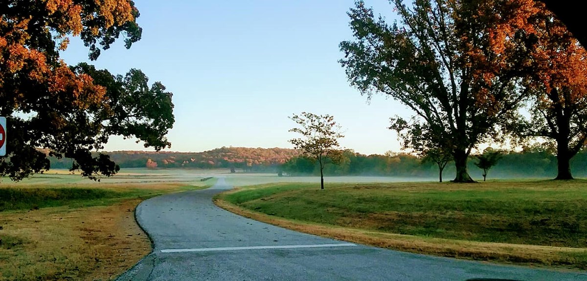 Fall photo of the parks driving tour road. Photo taken in the early morning on a fall day with fog hovering over the battlefield.