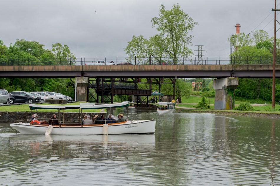 Three electronic launch boats with canopies float out of Cushwa Basin and into the Canal. Three electronic launch boats with canopies float out of Cushwa Basin and into the Canal.