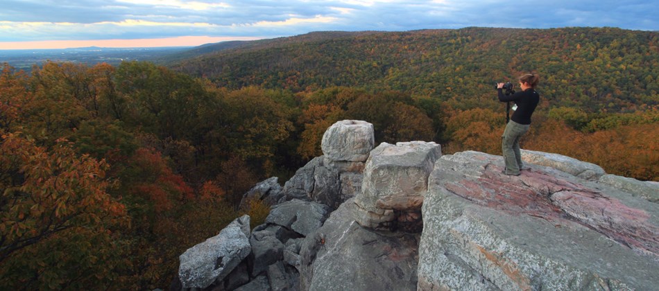 Photographer capturing fall foliage at Chimney Rock. Photographer capturing fall foliage at Chimney Rock.