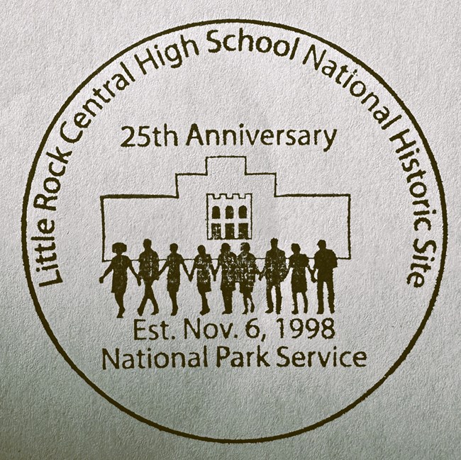 Junior ranger badge reads, "Central High School National Historic Site 25th anniversary 2023" and shows the sihouettes of nine figures walking in front of the main facade at Central High.
