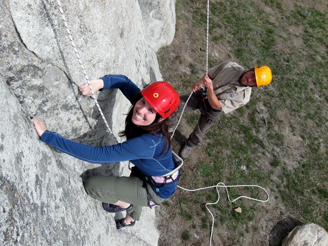 Picture of climbing instructor with student on a climb.