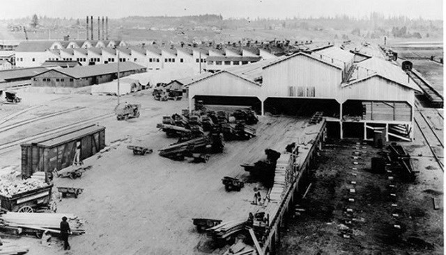 Black and white photo of large loading shed buildings.