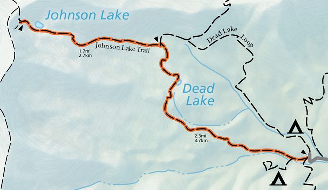 A color image of a cropped version of the official map of the national park. A grey road terminates on the right, and an orange highlighted trail emerges from it, stretching across the rest of the image. The trail is labeled in two sections.