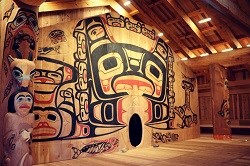traditional alaska native carvings on a screen inside of a large building