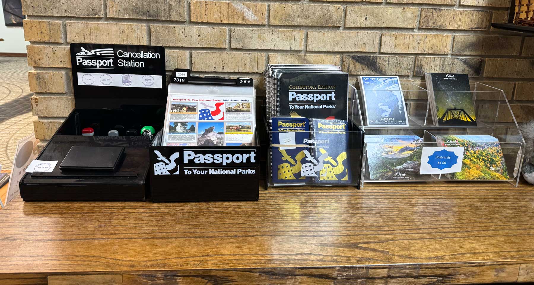 Wooden tabletop with the park's passport stamp sitting ontop.