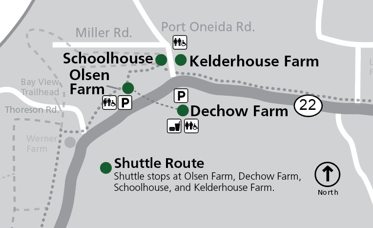 This map shows the Port Oneida area within Sleeping Bear Dunes National Lakeshore, focusing on shuttle stops and historic farm sites along M-22. This map shows the Port Oneida area within Sleeping Bear Dunes National Lakeshore, focusing on shuttle stops and historic farm sites along M-22. The map is oriented with north at the top, as indicated by a compass rose. The primary road, M-22, runs horizo