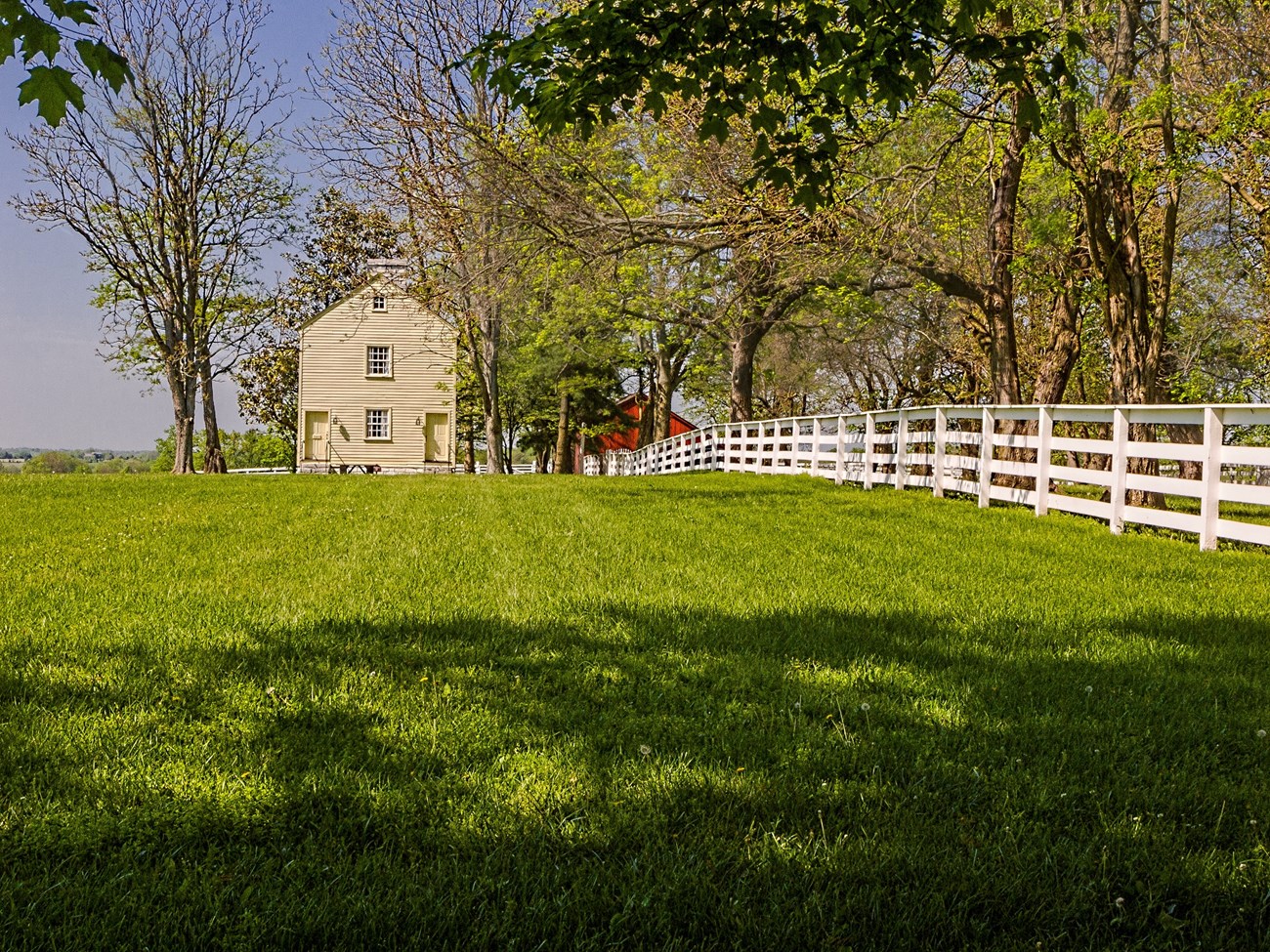 fence leading to a simple clapboard building