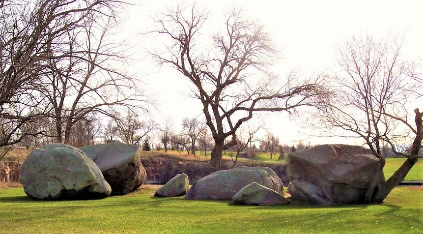 Large boulders among trees and grass