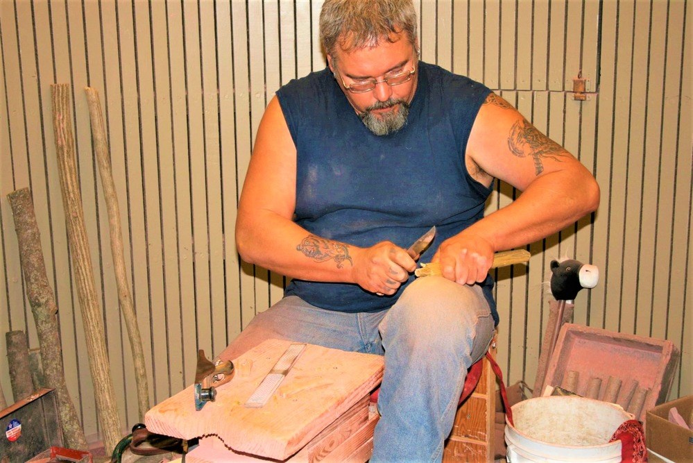Carving demonstrator A man carving a stick
