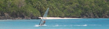 Windsurfer ride the waves in Cinnamon Bay Windsurfer ride the waves in Cinnamon Bay