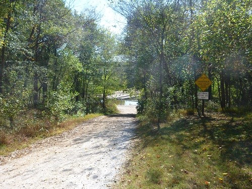 carver access gravel road through trees to river