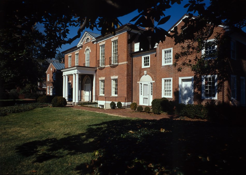 Color photograph of the outside of the Dumbarton House, made of red brick. Color photograph of the outside of the Dumbarton House, made of red brick.