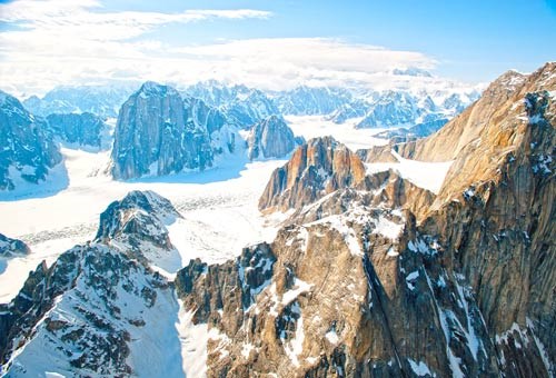 flightseeing alaska range aerial view of rugged mountains with a narrow glacier snaking among them