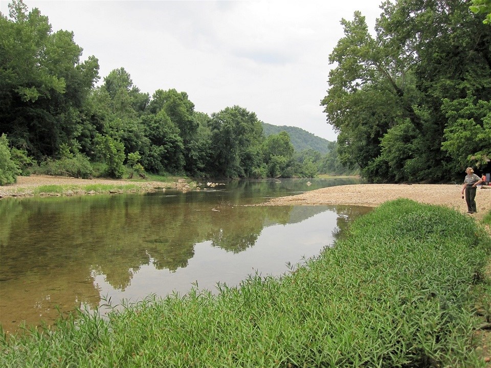 mt. hersey river with green grass and tan gravel at right