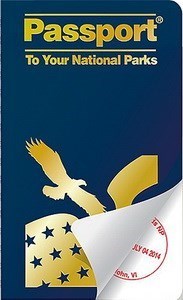 blue booklet titled Passport to your National Parks and a stamp revealed under curled corner.